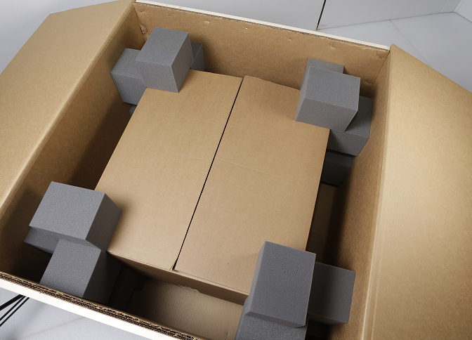 Open Unicorr corrugated box with custom foam inserts protecting inner contents.